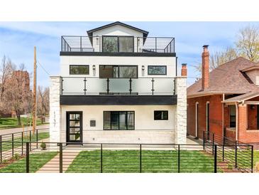Modern three-story home featuring multi-level balconies and a sleek black metal fence at 1757 W 36Th Ave, Denver, CO 80211