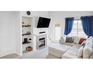 Bright living room with fireplace and comfortable sectional sofa at 6013 Castlegate Dr # D33, Castle Rock, CO 80108