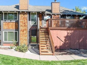 Charming townhouse featuring a private deck, well-maintained front yard, and shingle-style accents at 1314 S Dillon Way, Aurora, CO 80012