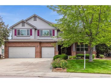 Charming two-story home with a brick facade, three-car garage and manicured lawn at 10440 Lowell Ct, Westminster, CO 80031