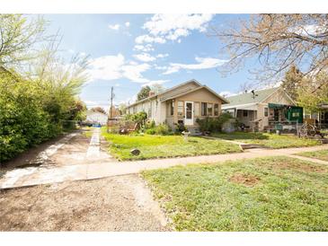 Charming single story home with a well maintained front yard and cozy curb appeal at 2235 Eaton St, Edgewater, CO 80214