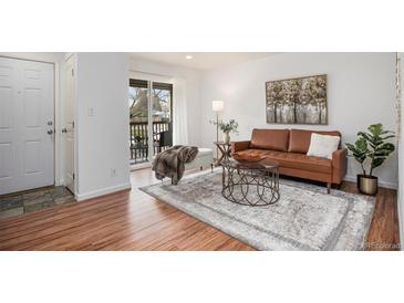 Bright living room with wood floors, balcony access, and stylish decor at 5300 E Cherry Creek South Dr # 1327, Denver, CO 80246
