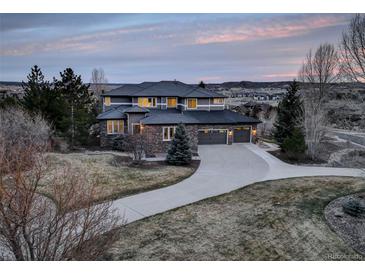Beautiful multi-story home featuring a long driveway and attached two-car garage at dusk at 5334 Sedona Dr, Parker, CO 80134