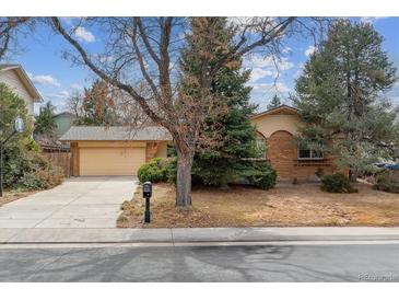 Charming single-Gathering home featuring a brick facade and mature trees in a well-maintained front yard at 12014 E Mexico Ave, Aurora, CO 80012
