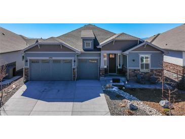 Charming single-Gathering home featuring a three-car garage and stone accents at 21916 E Swallow Pl, Aurora, CO 80016