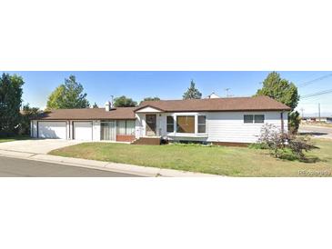 Charming single-story home with a well-maintained front yard and an attached two car garage at 609 S 1St Ave, Brighton, CO 80601