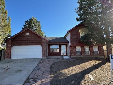 Charming two-story home featuring a spacious two-car garage and well-manicured front yard at 1719 S Ensenada Way, Aurora, CO 80017