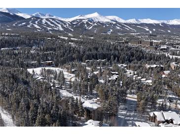 Aerial view of a snowy mountain resort community with homes and trees at 246 Broken Lance Dr # 503, Breckenridge, CO 80424