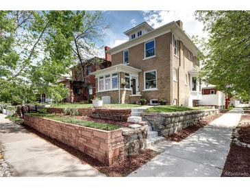 Charming brick two-story home with landscaped front yard and inviting entryway at 2 N Pennsylvania St, Denver, CO 80203