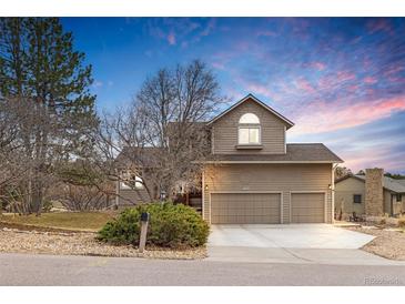 Charming two-story home with a well-manicured lawn, mature trees, and an attached two-car garage at 8150 Tempest Ridge Way, Parker, CO 80134