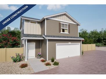 Charming two-story home with an attached garage, neutral siding, and inviting front yard landscaping at 46541 Sunflower Ln, Bennett, CO 80102