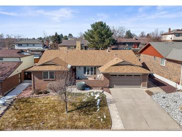 Charming brick ranch home with a two-car garage and a well-maintained front yard at 4621 S Perry Way, Denver, CO 80236