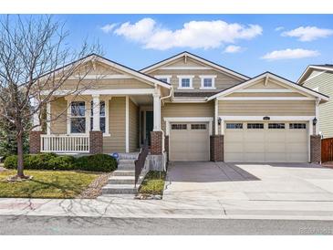 Charming exterior of home with a porch, well-maintained lawn, and two car garage at 6013 Eldora St, Golden, CO 80403