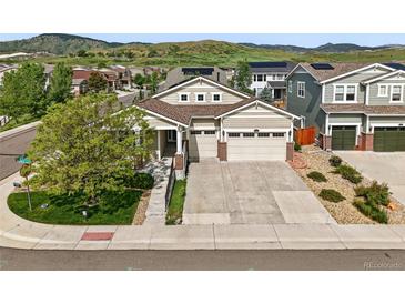 Beautiful home with a two-car garage, well maintained lawn, and excellent curb appeal at 6013 Eldora St, Golden, CO 80403