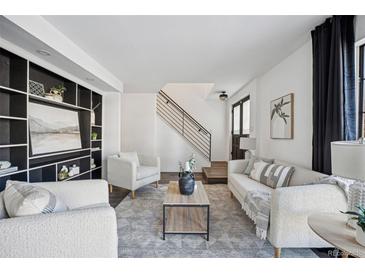 Bright living room with comfy seating and built-in shelving at 10360 E Jewell Ave # 95, Aurora, CO 80247