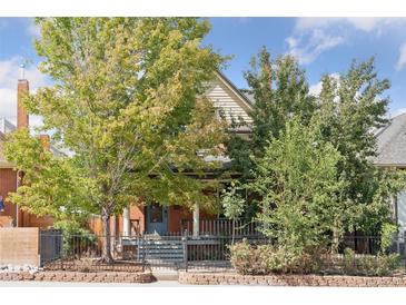 Charming two-story home with a brick facade and porch at 2771 W 38Th Ave, Denver, CO 80211