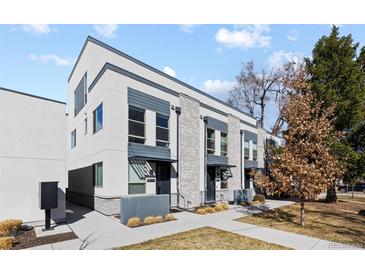 Modern townhouse exterior showcasing stylish architecture and well-maintained landscaping on a sunny day at 3875 E 4Th Ave # 2, Denver, CO 80206