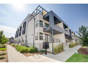 Modern condo building with balconies, clean lines and contemporary design under a bright sky at 2400 S Delaware St # 1, Denver, CO 80223