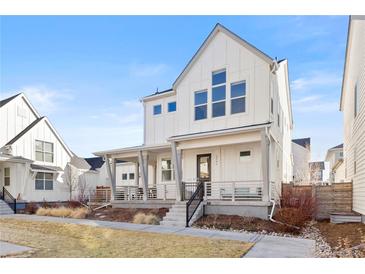 Charming two-story home features a welcoming front porch and well-maintained landscaping at 5984 Fulton St, Denver, CO 80238