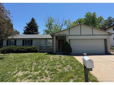 Charming single Gathering home with a well-manicured lawn and a two-car garage at 16180 E Flora Pl, Aurora, CO 80013