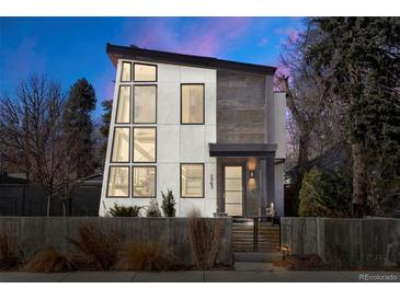 Modern two-story home featuring a unique architectural design with large windows and professional landscaping at 1763 S Williams St, Denver, CO 80210