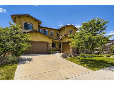 Two-story home featuring a two-car garage, landscaped yard and appealing architecture at 14074 Yellow Tip Dr, Parker, CO 80134