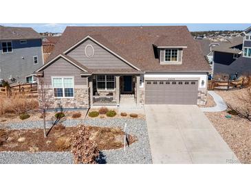 Charming single-Gathering home with a well-manicured front yard and attached two-car garage at 23579 E Swallow Cir, Aurora, CO 80016