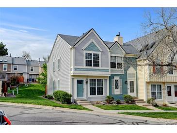 Charming townhome featuring two-story facade with landscaped yard and colorful exterior finishes at 9188 W Ontario Dr, Littleton, CO 80128