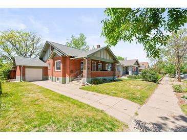 Charming brick home with a well-maintained front yard and inviting curb appeal in a desirable neighborhood at 4945 Perry St, Denver, CO 80212