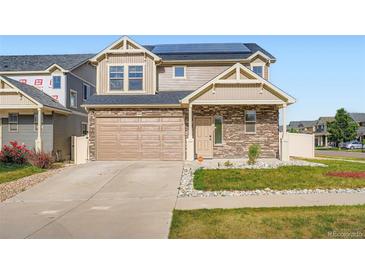 Charming two-story home featuring stone accents, a two-car garage, and solar panels for energy efficiency at 4404 Walden St, Denver, CO 80249