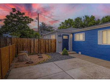 Charming home featuring a blue exterior, welcoming entrance, and modern landscaping with a wooden fence at 1021 Stuart St, Denver, CO 80204