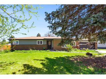 Charming single-story brick home with a well-manicured lawn and mature trees at 6212 S Pennsylvania St, Centennial, CO 80121