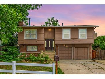 Charming split level home featuring a two car garage, and a well-maintained yard at 9832 High St, Thornton, CO 80229