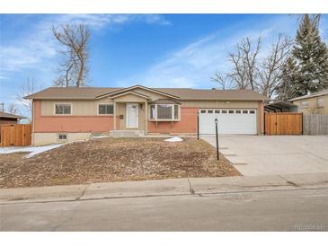 Charming single Gathering home featuring a well-manicured yard and a spacious two-car garage at 12022 W Dakota Dr, Lakewood, CO 80228