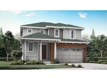 Charming two-story home featuring a brick-accented garage, covered porch, and lush lawn at 7307 S Yank Ct, Littleton, CO 80127