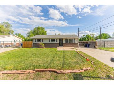 Charming home with a well-manicured lawn and inviting curb appeal on a sunny day at 2630 W Asbury Ave, Denver, CO 80219