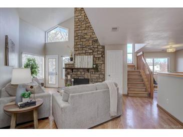 Spacious living room with stone fireplace and vaulted ceilings at 5690 W 80Th Pl # 91, Arvada, CO 80003