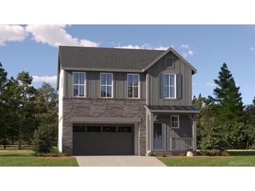 Charming two-story home with stone accents and a covered front porch, surrounded by lush trees and greenery at 2150 S Haleyville Way, Aurora, CO 80018