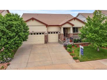 Charming single Gathering home showcasing a three-car garage, beautiful landscaping, and inviting front porch at 6618 Lynch Ln, Castle Rock, CO 80108