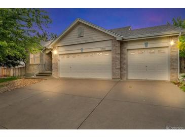 Charming home featuring a two-car garage and a well-maintained driveway and front yard at 5960 S Estes St, Littleton, CO 80123