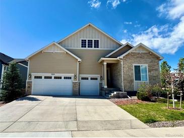 Charming two-story home features a stone accent and three-car garage for ample parking at 8440 Rush Creek Ave, Littleton, CO 80125