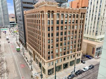 Brick exterior of the Midland Lofts, with a vintage design and many windows in a busy downtown environment at 444 17Th St # 603, Denver, CO 80202