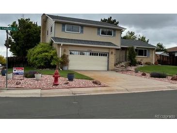 Charming two-story home boasts a well-maintained yard, complemented by tasteful landscaping and a convenient two-car garage at 13266 Canopus Dr, Lone Tree, CO 80124