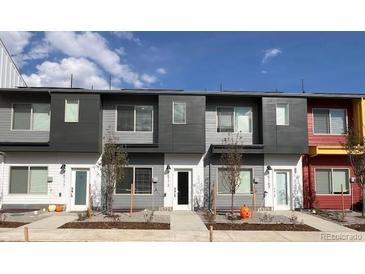 Modern townhome exterior boasts clean lines and attractive color palette at 15275 W 68Th Pl, Arvada, CO 80007