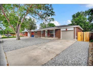 Charming brick home featuring a well-maintained front yard and a convenient attached garage at 61 S 17Th Avdr, Brighton, CO 80601