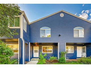 Exterior view of the blue siding, multi-Gathering home with covered entryway and manicured landscaping at 3294 Sentinel Dr, Boulder, CO 80301