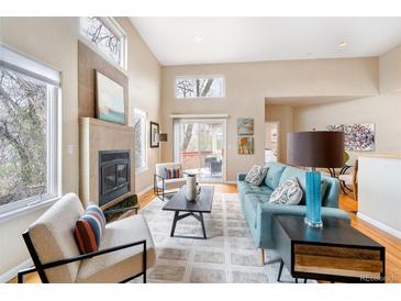 Bright living room boasts high ceilings, fireplace, and comfortable seating area at 2304 S Holly St # A, Denver, CO 80222