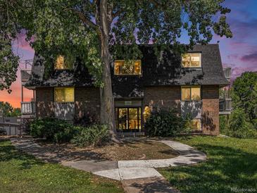 Charming brick apartment building with well-maintained landscaping and mature trees at 309 E Highline Cir # 104, Centennial, CO 80122