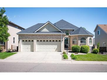 Lovely two-story home with a three car garage and manicured front yard at 7007 S Garrison St, Littleton, CO 80128