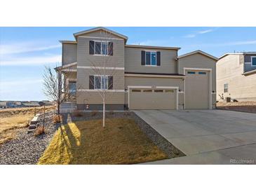 Beautiful two-story home with a two car garage and well-manicured lawn at 42855 Hawktree Cir, Elizabeth, CO 80107
